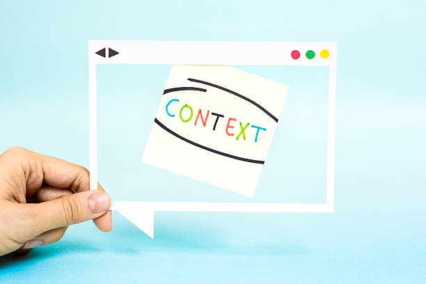 istock Hand holding speech bubble with word Context. 
