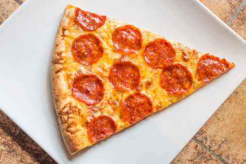 Closeup view of a slice of a pepperoni pizza