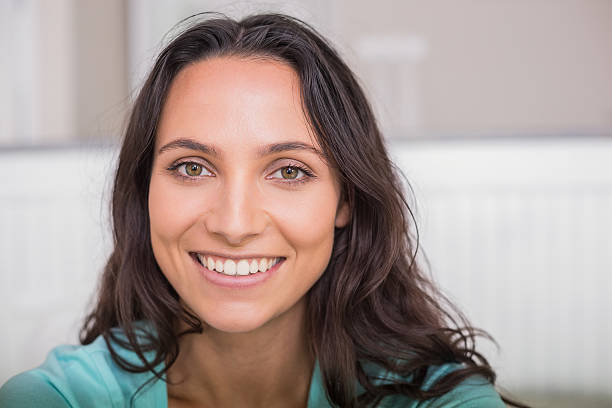 istock Happy brunette sitting on bed 482215658