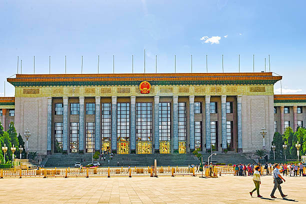 People,  citizens of Beijing, walk on Tiananmen Square. Beijing, China- May 19, 2015: People,  citizens of Beijing, walk on Tiananmen Square near Chinese Parliament, Beijing.China. forbidden city beijing architecture chinese ethnicity stock pictures, royalty-free photos & images