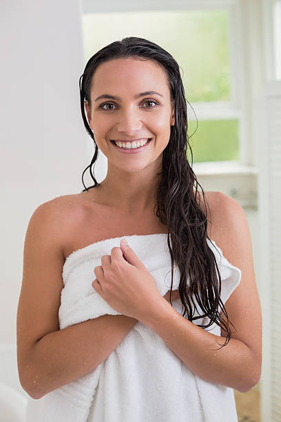 istock Pretty brunette holding her bath towel 482221250