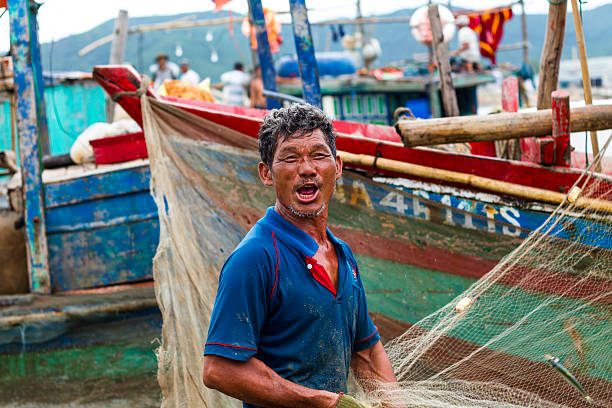 Fisherman Nghean, Vietnam - July 18, 2015: Portrait Vietnamese fishermen on the beach in Vietnam vietnamese old man portrait stock pictures, royalty-free photos & images