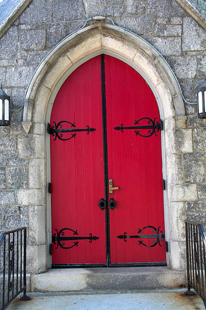 istock Red arched doors, black ironwork, stone church, Keene, New Hampshire. 482224480