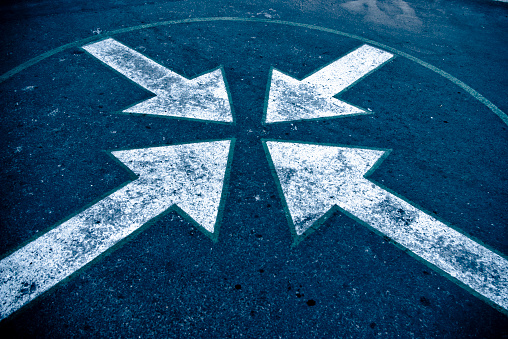 four arrows on asphalt on the street