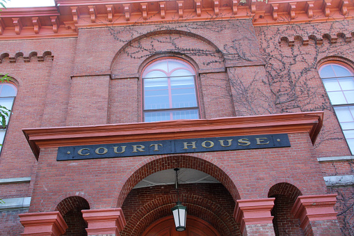 Red brick facade of the Court House, closeup, horizontal looking up, downtown Keene, New Hampshire.