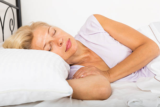 istock Middle-aged woman sleeping in bed 482231332