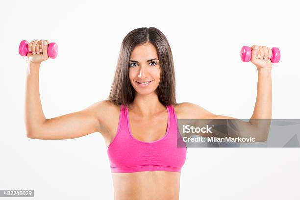 Fitness Woman Lifting Dumbbells Stock Photo - Download Image Now - 20-24 Years, 20-29 Years, Active Lifestyle
