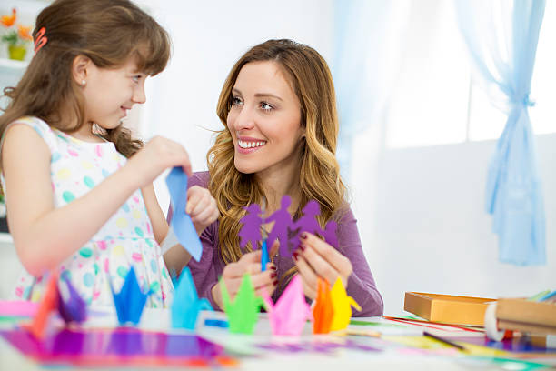 istock Mother and daughter making origami. 482249061