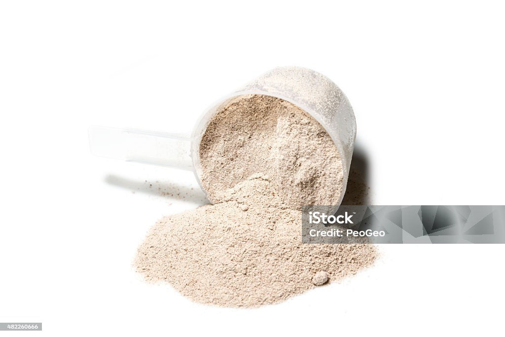 Scoop of Isolate protein powder chocolate deluxe flavour  poured Scoop of Isolate protein powder chocolate deluxe flavour  poured isolated on white background Protein Stock Photo