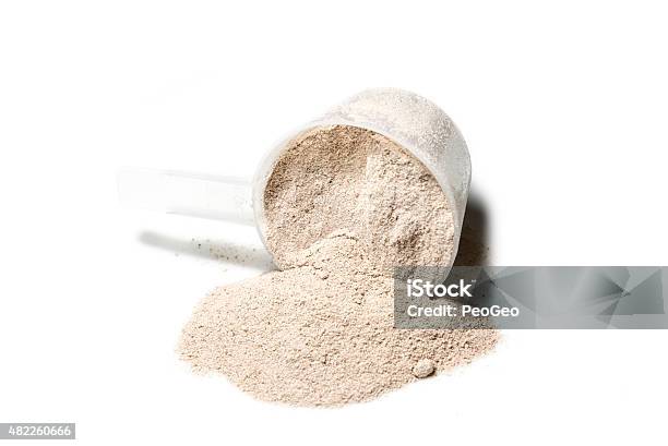 Scoop Of Isolate Protein Powder Chocolate Deluxe Flavour Poured Stock Photo - Download Image Now