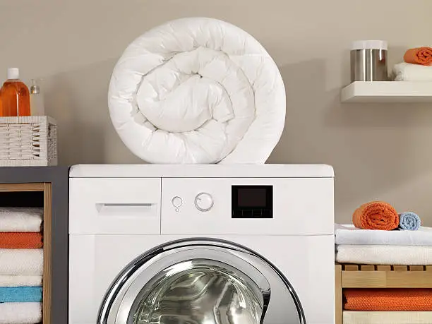 folded laundry on a washing machine