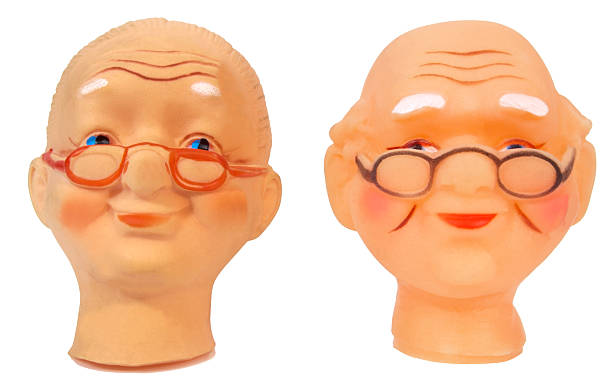 Vintage arts and crafts doll heads of elderly grandpa and grandma. Horizontal.