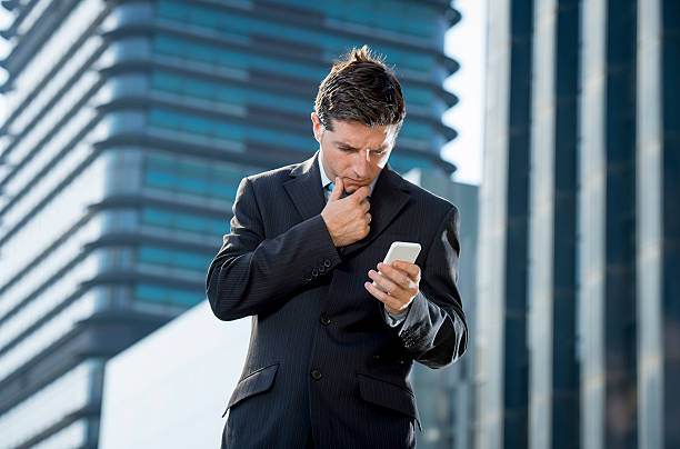 istock businessman talking on mobile phone outdoors financial district in stress 482263574