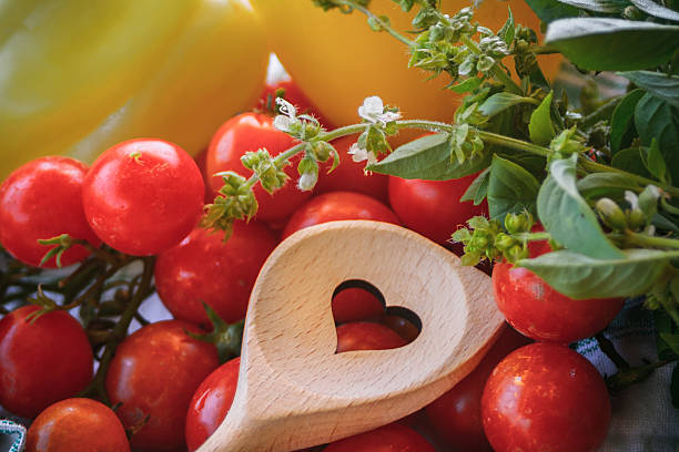 Heart hole spoon and vegetables stock photo