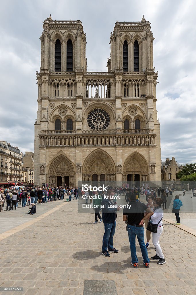 Tourists visiting the Notre Dame cathedral in Paris, France Paris, France  - May 29, 2015:  Tourists waiting in front of the Notre Dame for a visit at this wold famous cathedral in Paris, France 2015 Stock Photo