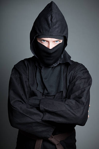istock caucasian man disguised as a ninja isolated on grey 482272511