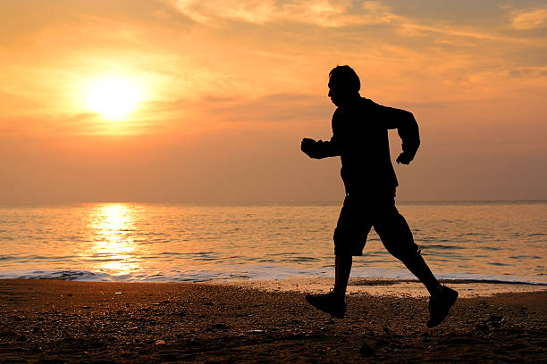istock Silhouette man running at the beach 482272828