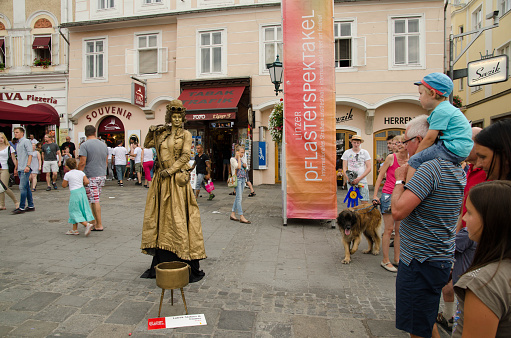 Linz, Austria - July 25, 2015: Artist Lutrek Statues from Poland at Pflasterspektakel Festival in Linz. The Pflasterspektakel is one of the biggest street art festivals in Europe –  theatre, music of all kinds, dance, circus artistry, high-wire and fire acrobatics as well as clownery is shown at the famous Pflasterspektakel festival. 