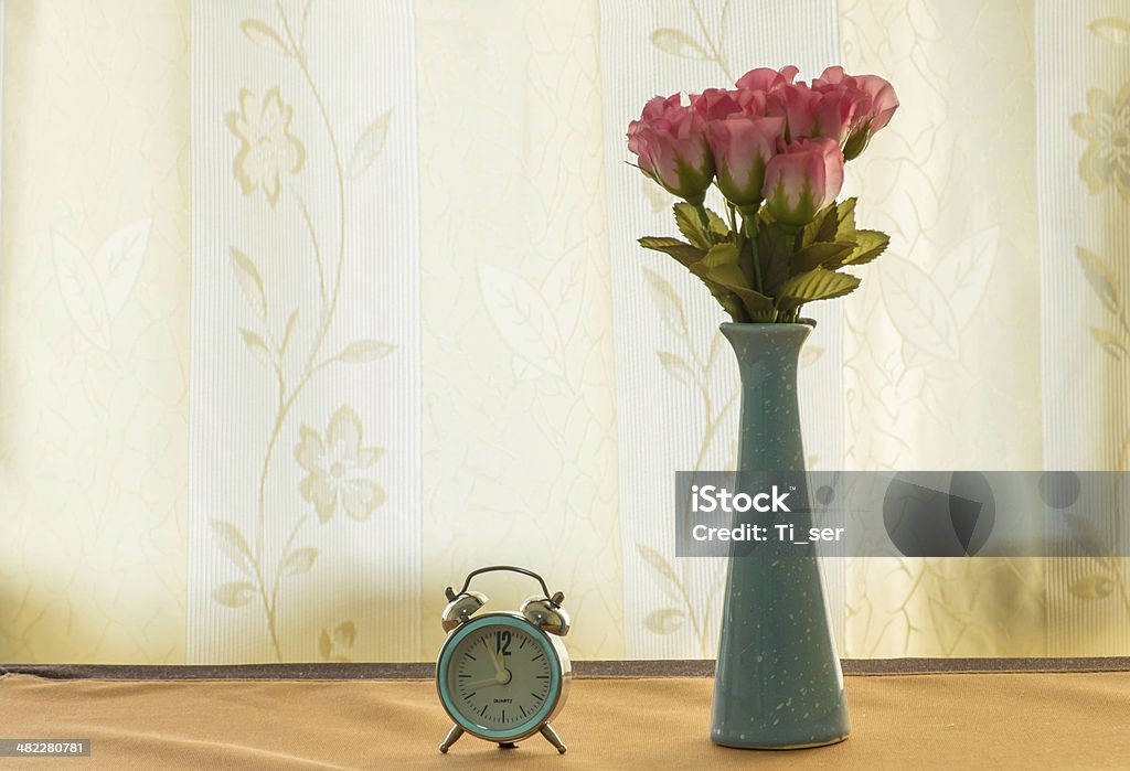 Rose on the Jar Rose on Jar with clock  near window. Arrangement Stock Photo