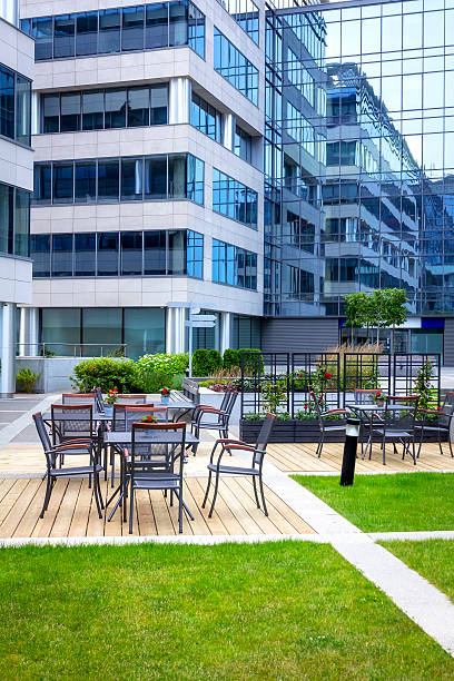 istock Green square with chairs in front of office buildings 482281488