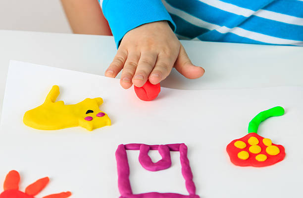 istock Child playing with clay molding shapes 482284871