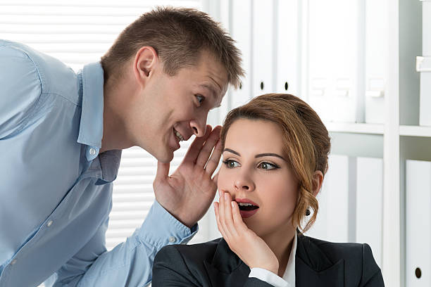 istock Young man telling gossips to his woman colleague 482285044