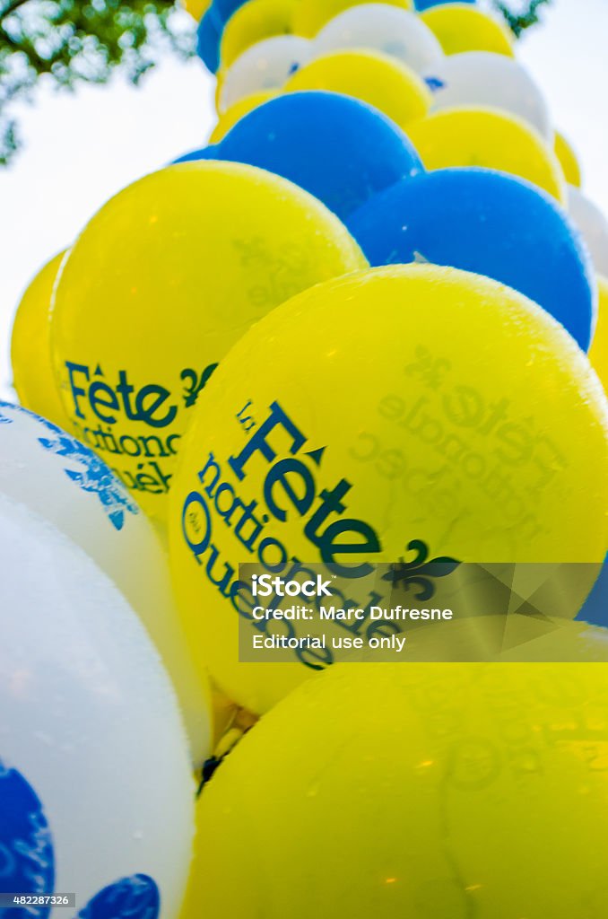 Balloons celabrating Quebec Day Quebec, Canada - June 23, 2015: Group of White, blue and yelow balloons with the Fleur-de-Lys and all attached together for the celebration of Quebec national day on June 24th taken on the summer evening before the festivity. 2015 Stock Photo