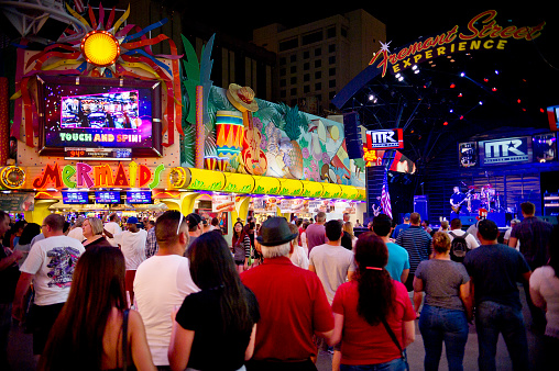 Las Vegas, Nevada, USA - July 4, 2015: A crowd watches a band playing, next to Mermaids Casino, on Fremont Street, Las Vegas, during the Indepedence Day celebrations.