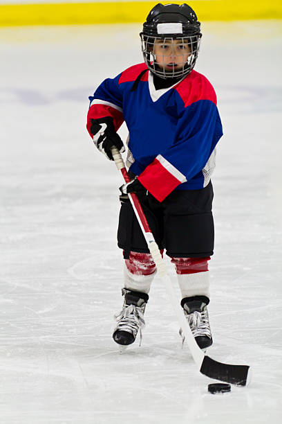 istock Child practices stickhandling at ice hockey practice 482289507
