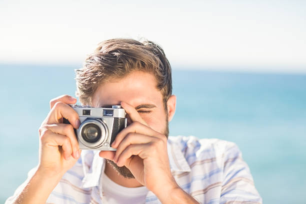 istock man taking a photo and looking at camera 482291608