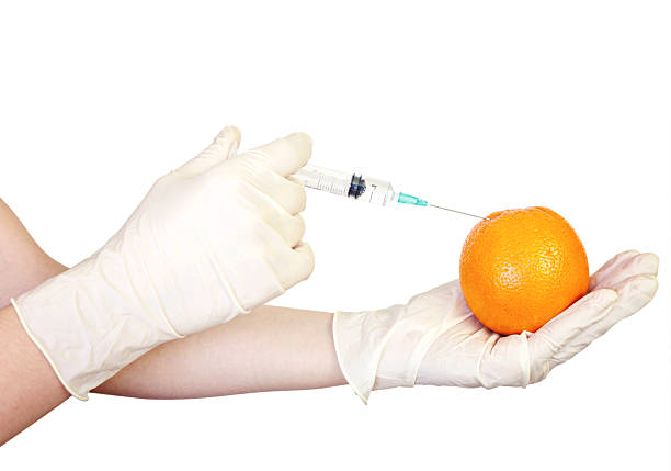 Injection into orange Injection into orange genetic modification change improvement science stock pictures, royalty-free photos & images