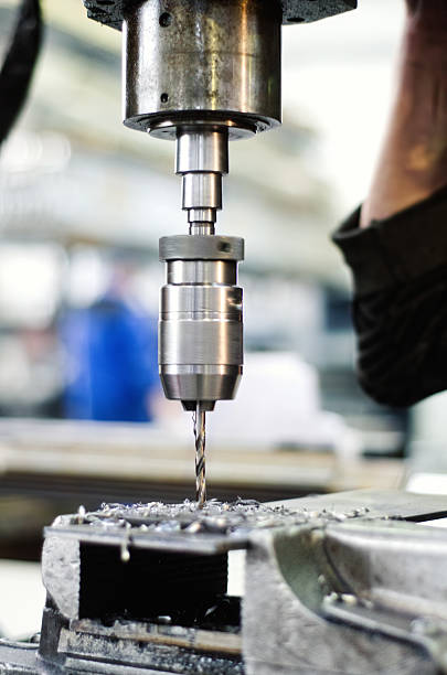 istock Industrial worker drilling a thin, hole in a metal bar 482300005