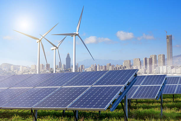 istock Solar panels and wind turbines with city 482300128