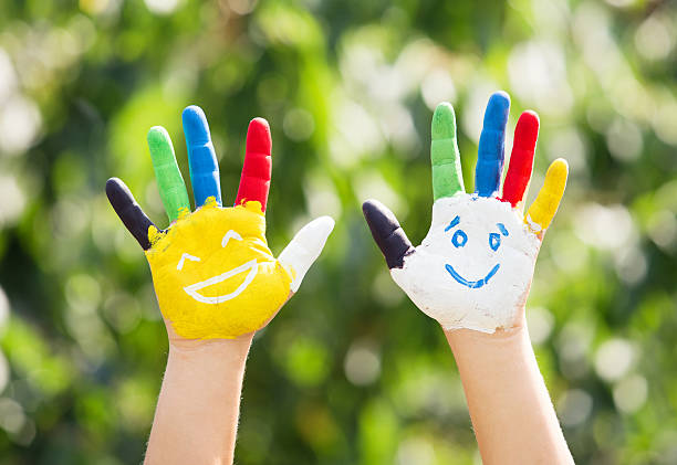istock Colored hands with smile painted in colorful paints 482302244
