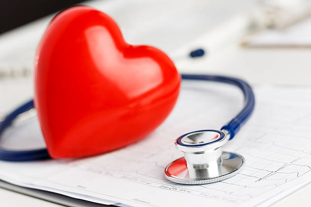 istock Medical stethoscope and red toy heart lying on cardiogram chart 482303432