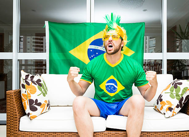 istock Brazilian fan celebrates at home 482305693