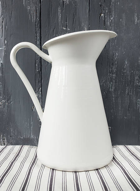 istock White metal milk pitcher on wood. 482307112