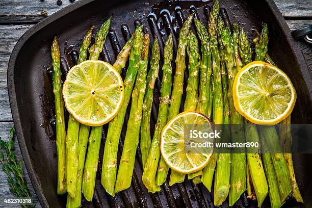 Grilled Organic Asparagus With Lemon Stock Photo - Download Image Now - Asparagus, Grilled, Baked