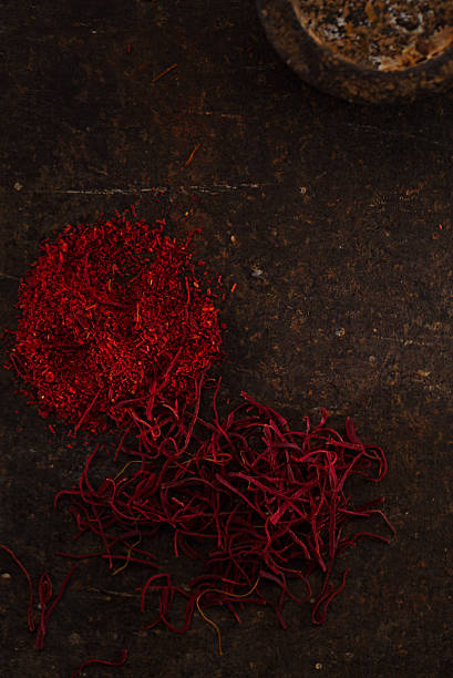 istock saffron spice in pile threads and powder on old metal 482311340