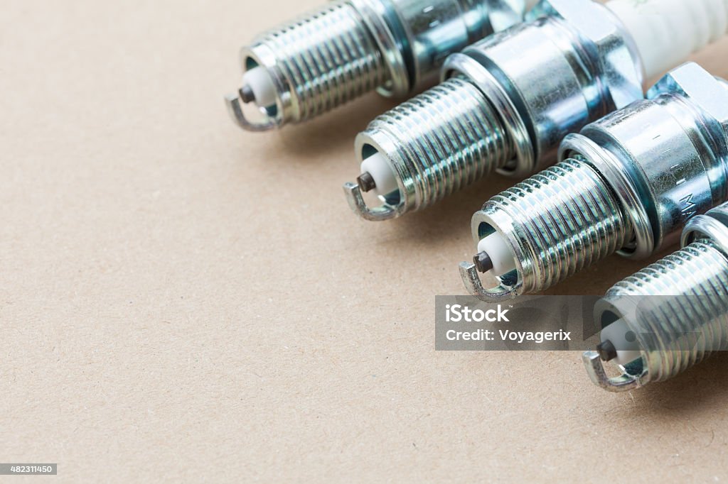 Auto service. Set of spark plugs spare part of car. Auto service. Set of new car spark plugs as spare part of auto transportation on gray 2015 Stock Photo