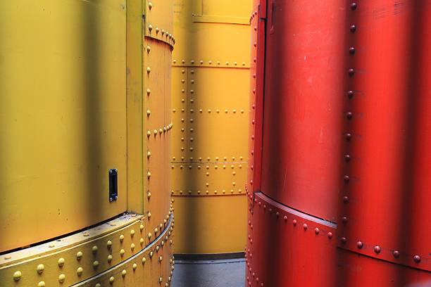 istock Red and yellow hydraulic cylinders behind a cage 482317136