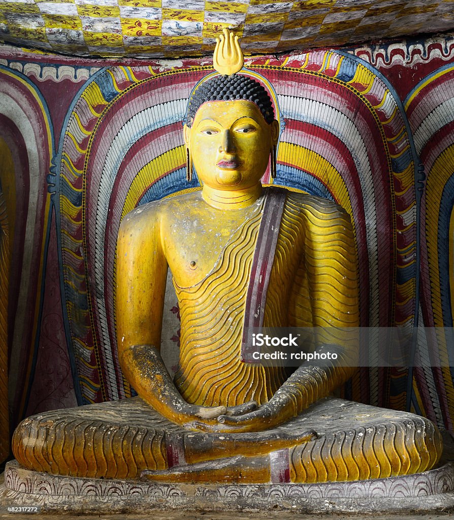 Sitting Buddha in Golden Temple of Dambulla, Sri Lanka Insides of caves in ancient Buddhist complex in Dambulla cave temple. Sri Lanka. The photograph is presenting the statue of sitting Buddha 2015 Stock Photo