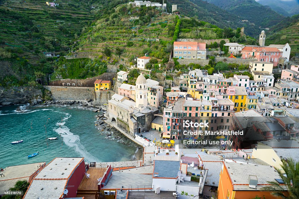 Cinque Terre Italy Town of Vernazza Vernazza, Italy - April 29, 2015: The Italian town of Vernazza rests precipitously along the edge of the cliffs in the Cinque Terre region.  Vernazza is one of the five villages.  The iconic painted houses of this area hang on the cliffs. 2015 Stock Photo