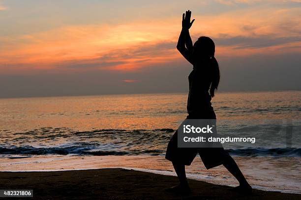 Silhouette Woman Yoga On The Beach Stock Photo - Download Image Now - Active Lifestyle, Adult, Adults Only