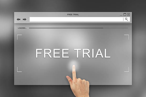 hand press on free trial button on website stock photo