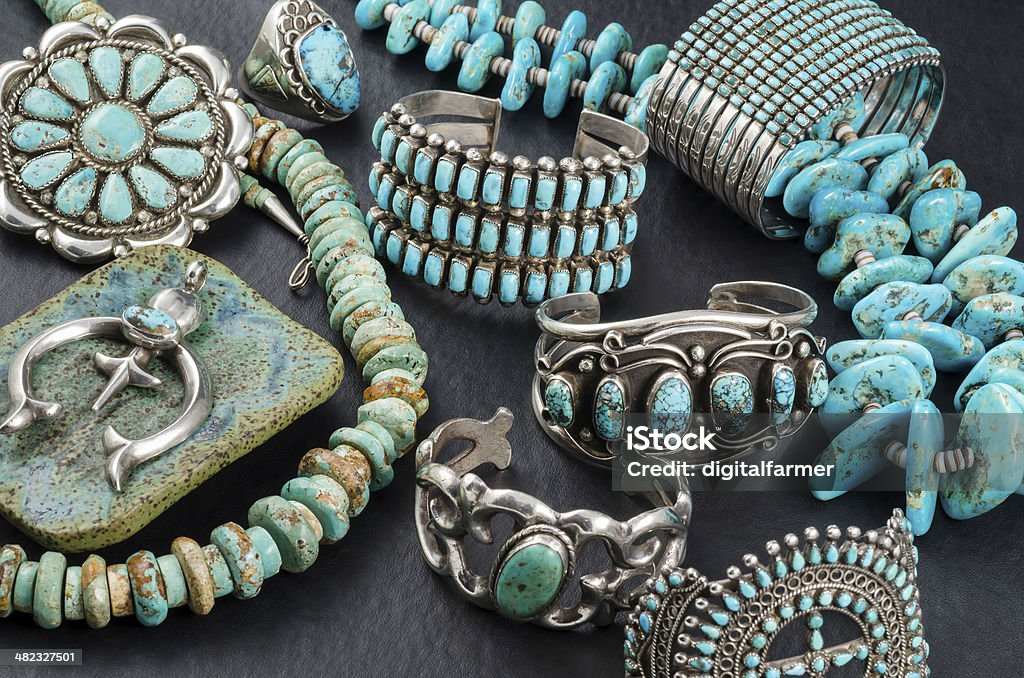 Collection of Native American Turquoise and Silver Jewelry. Vintage Native American Turquoise and Sterling Silver Jewelry, Necklaces, Bracelets and Concho on a black background. Turquoise - Gemstone Stock Photo