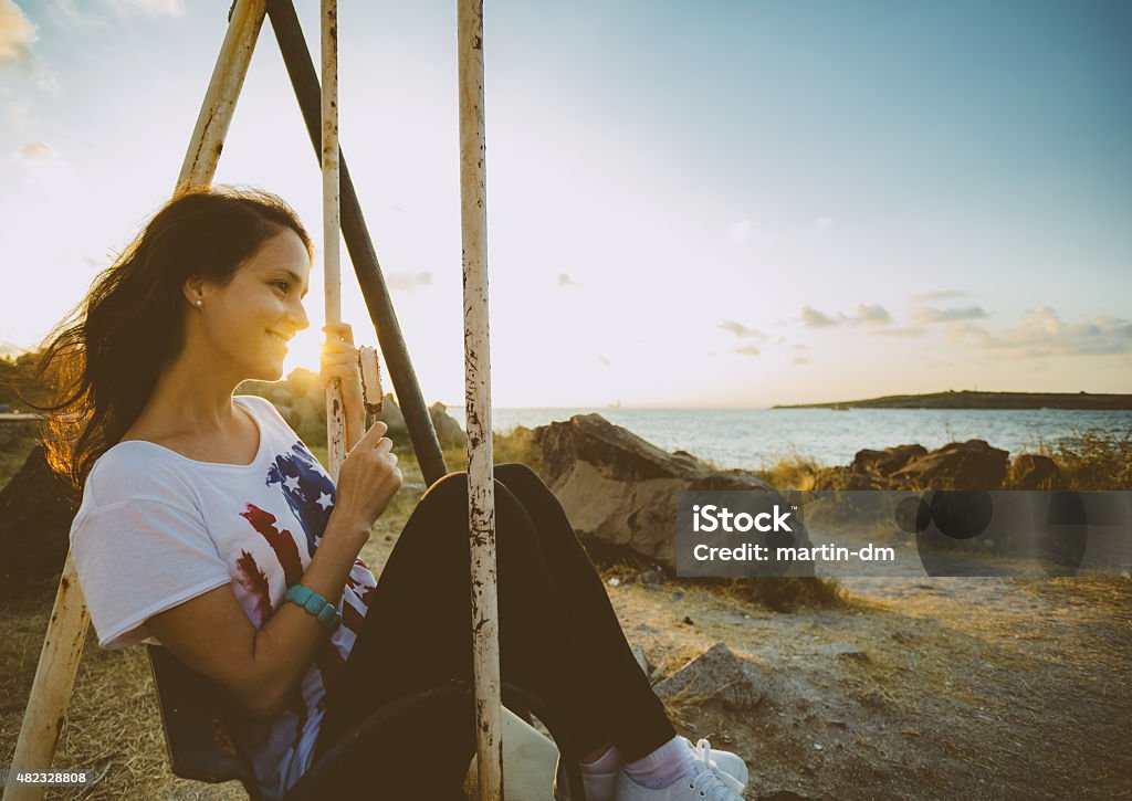 Girl swinging at sunset Lifestyle session Profile View Stock Photo