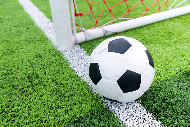 Soccer ball at line soccer goal.