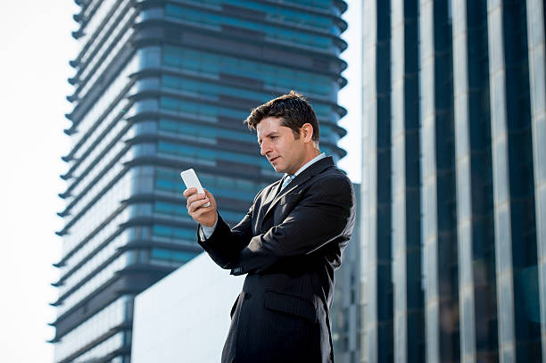 istock businessman talking on mobile phone outdoors financial district in stress 482333302