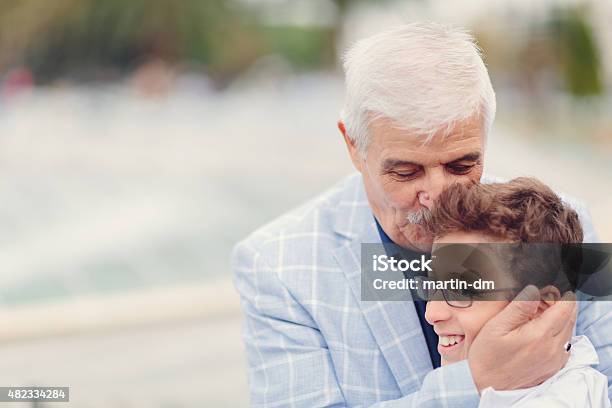 Grandfather Kissing His Grandson Stock Photo - Download Image Now - 14-15 Years, Embracing, Grandfather